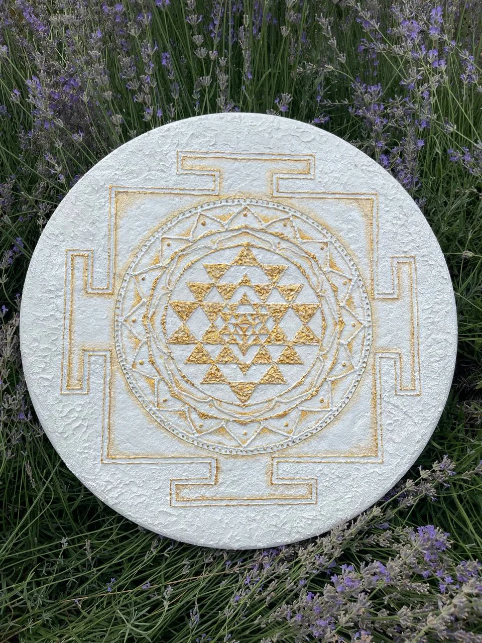 Sri Yantra — round textured white and gold painting (55 cm) by Marianna Nerozna among lavender flowers